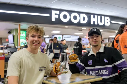 Students holding burgers