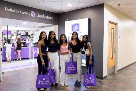 Students holding Bookstore shopping bags