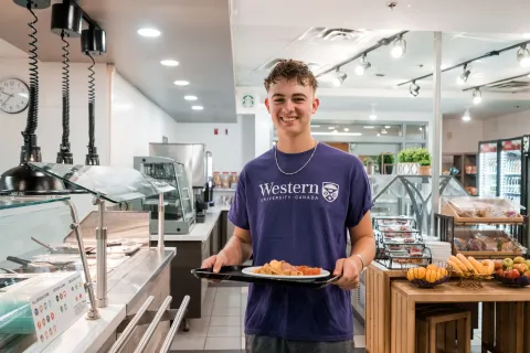Student holding tray of food